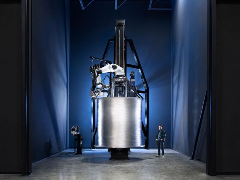 Co-founders standing in front of a piece of rocket ship printed by Stargate