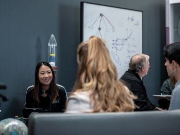 Aerospace Corporation employees discussing space in the Mathematics Lab