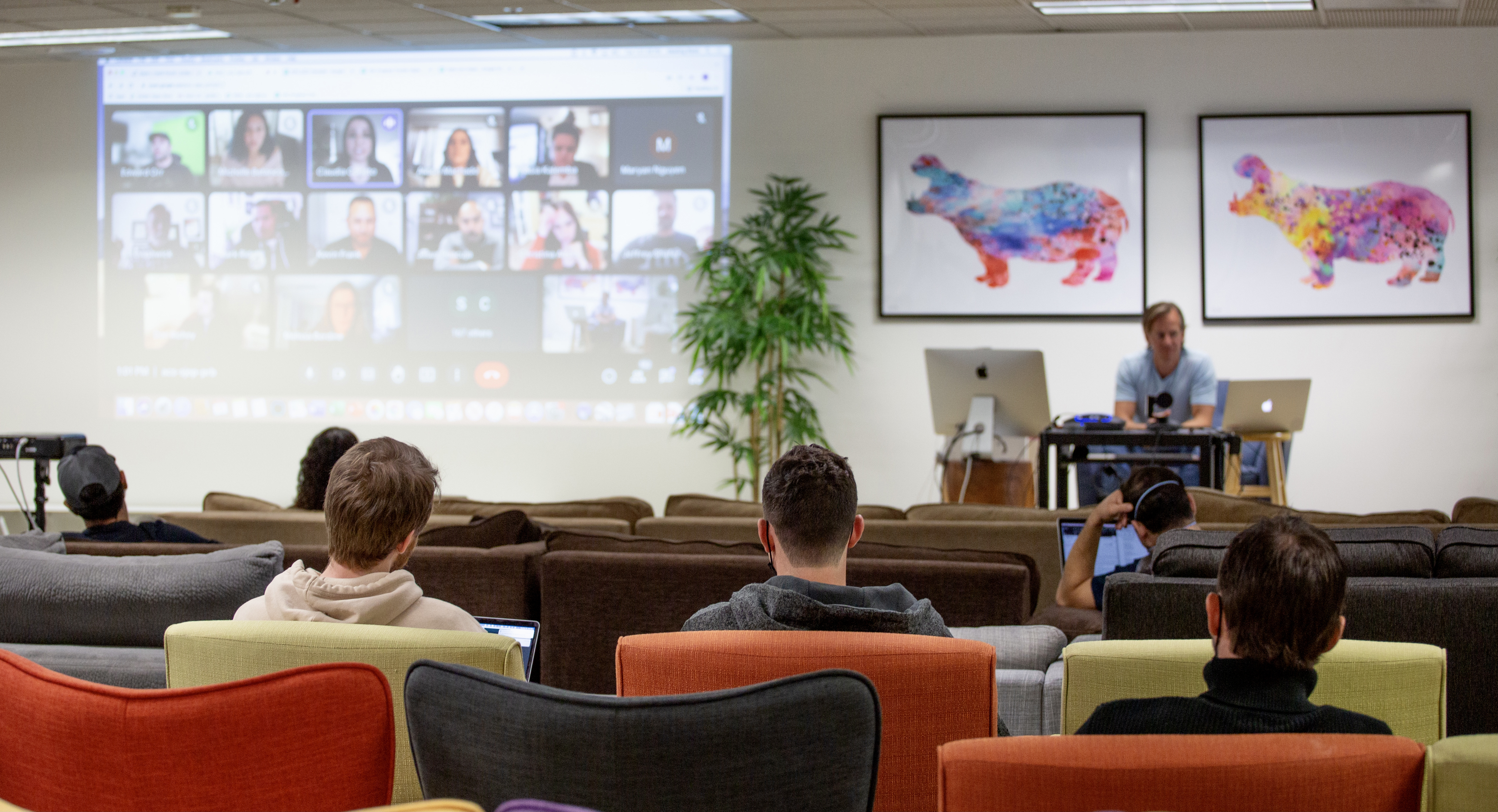 Golden Hippo team members attend a hybrid work event in person and remotely