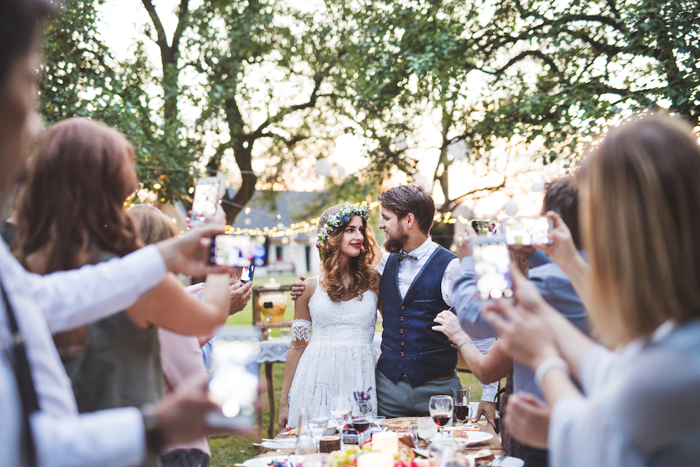 Wedding guests taking smartphone photos