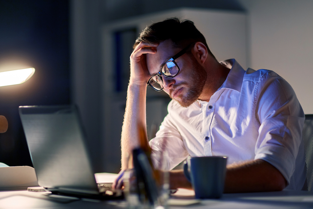 A stressed man at a computer