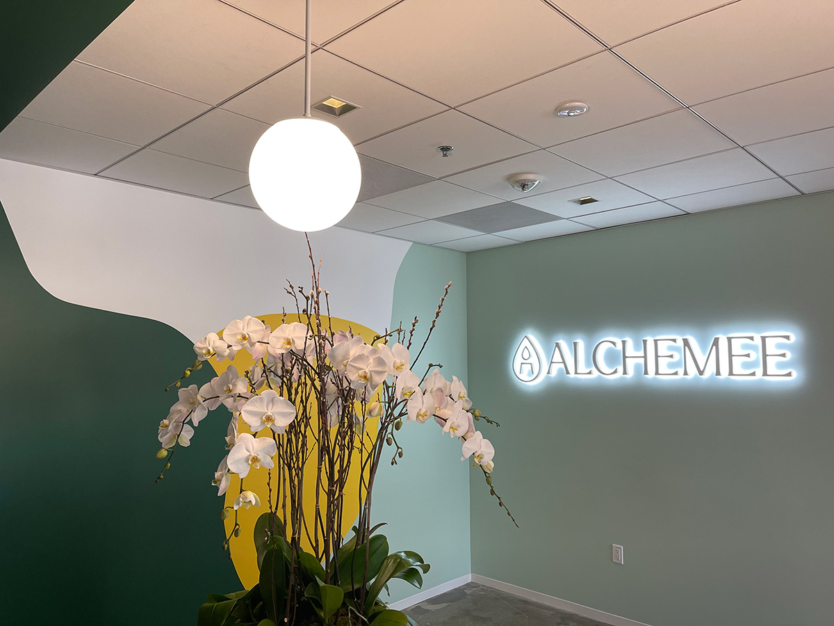 Alchemee logo on the wall in the office