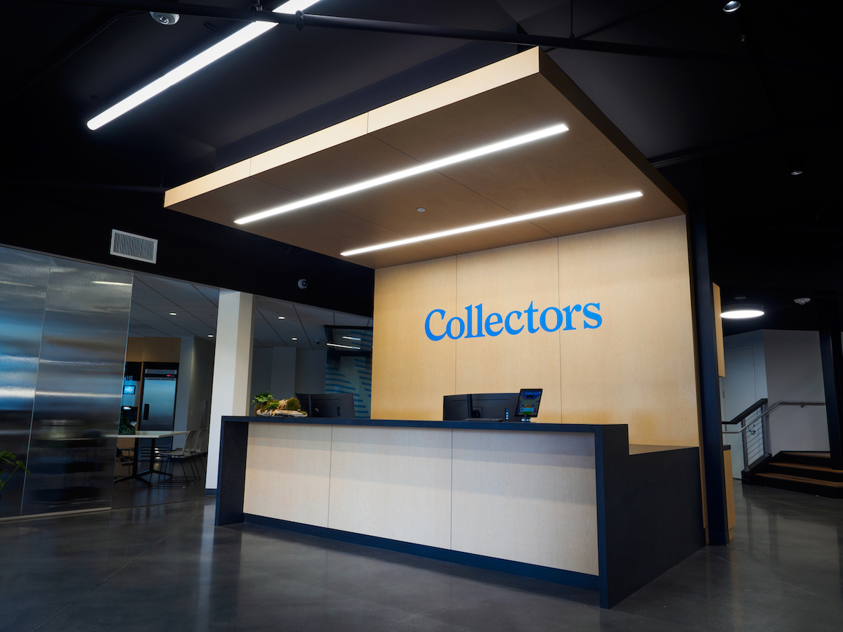 A light-colored wood wall displays the word Collectors in blue lettering