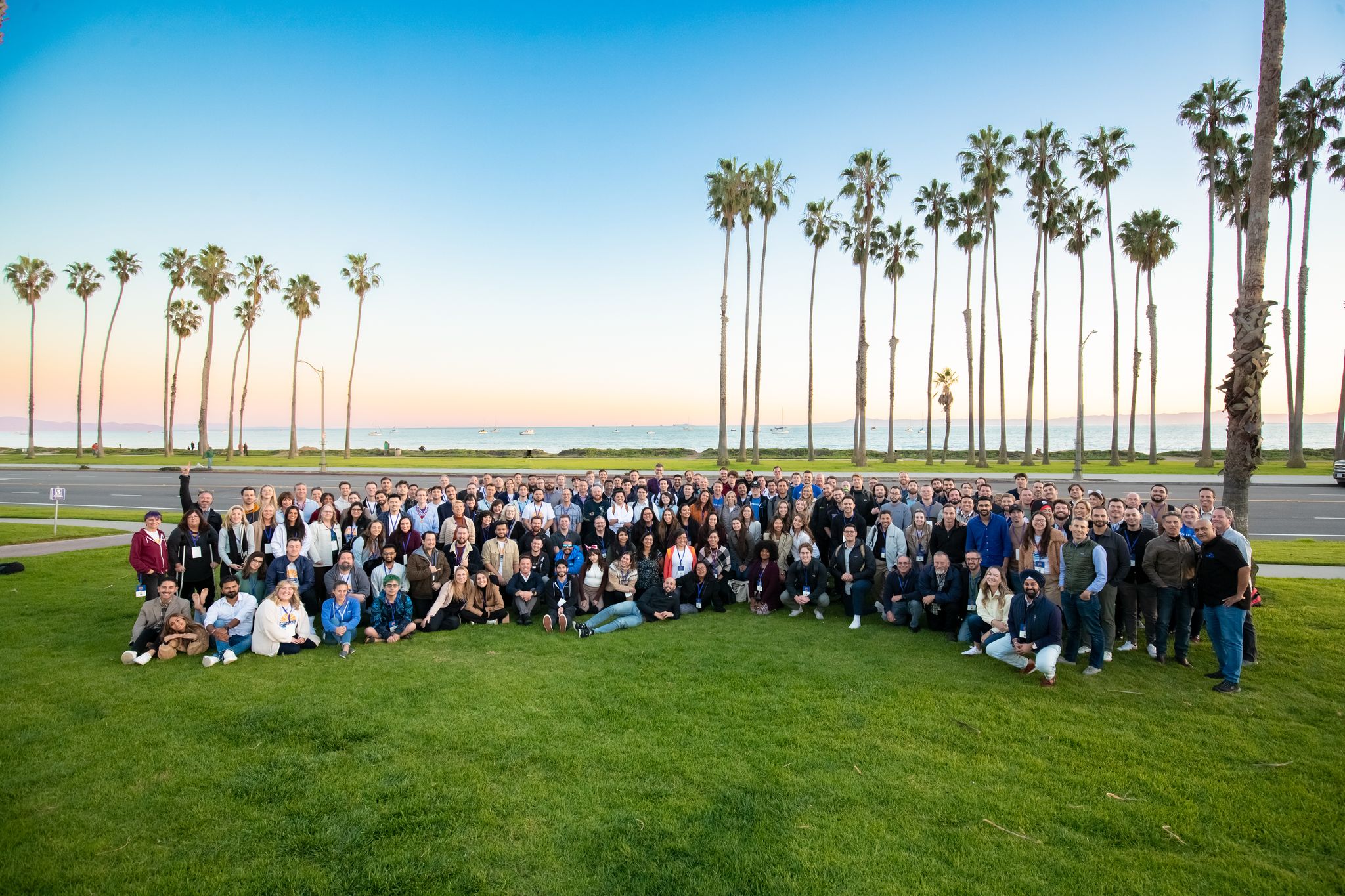 HG Insights' company photo on a green expanse under palm trees