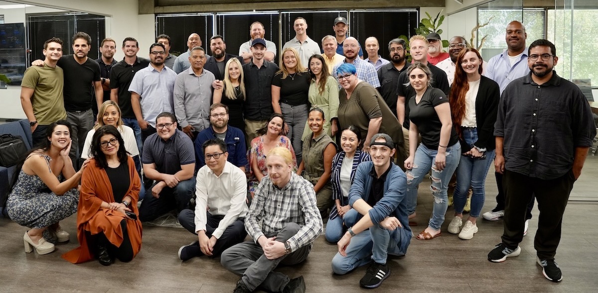 The large Convoso team poses for a group photo in an office setting