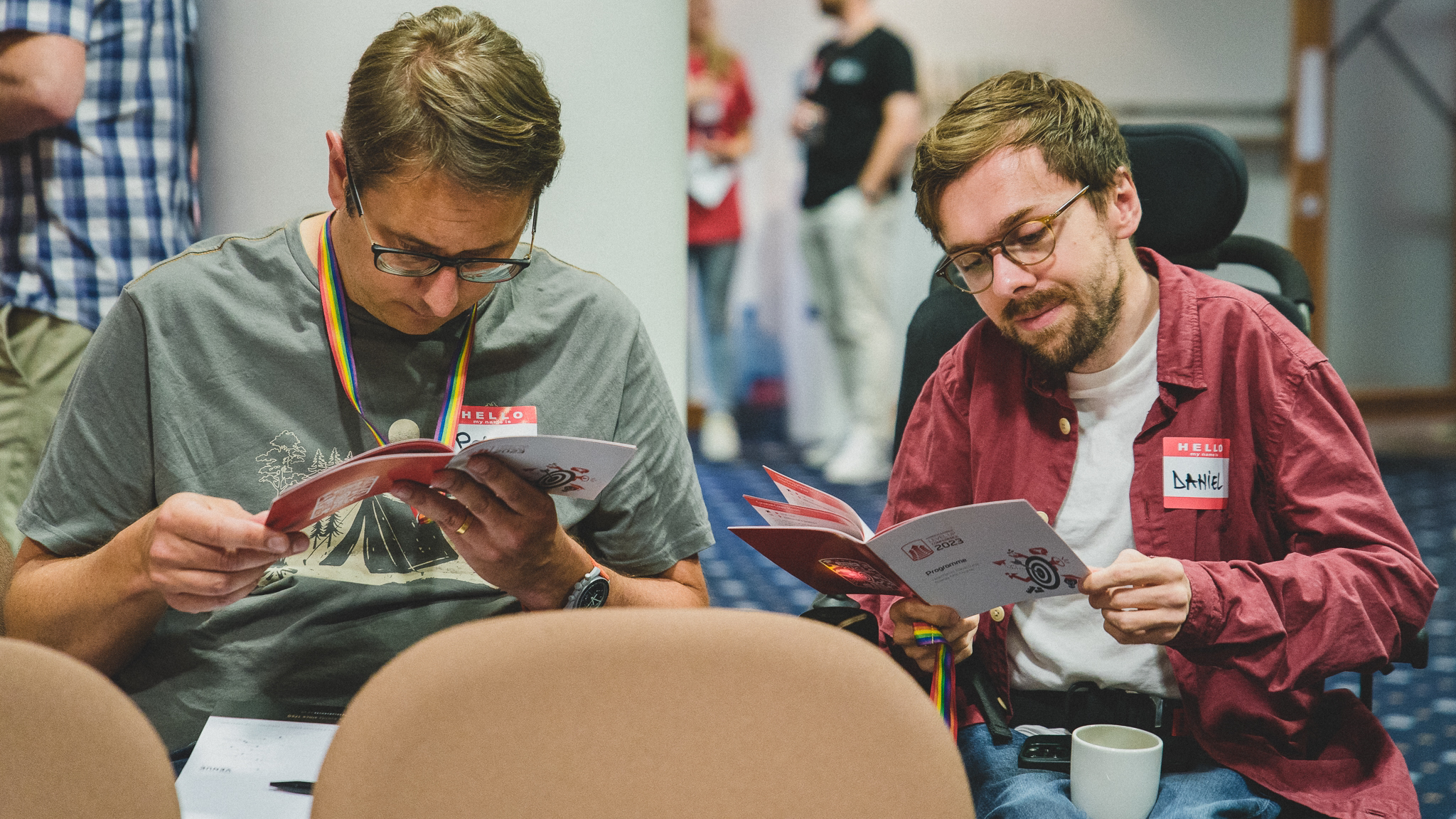 Two Redgate team members read a pamphlet at an internal conference that promoted inclusion.