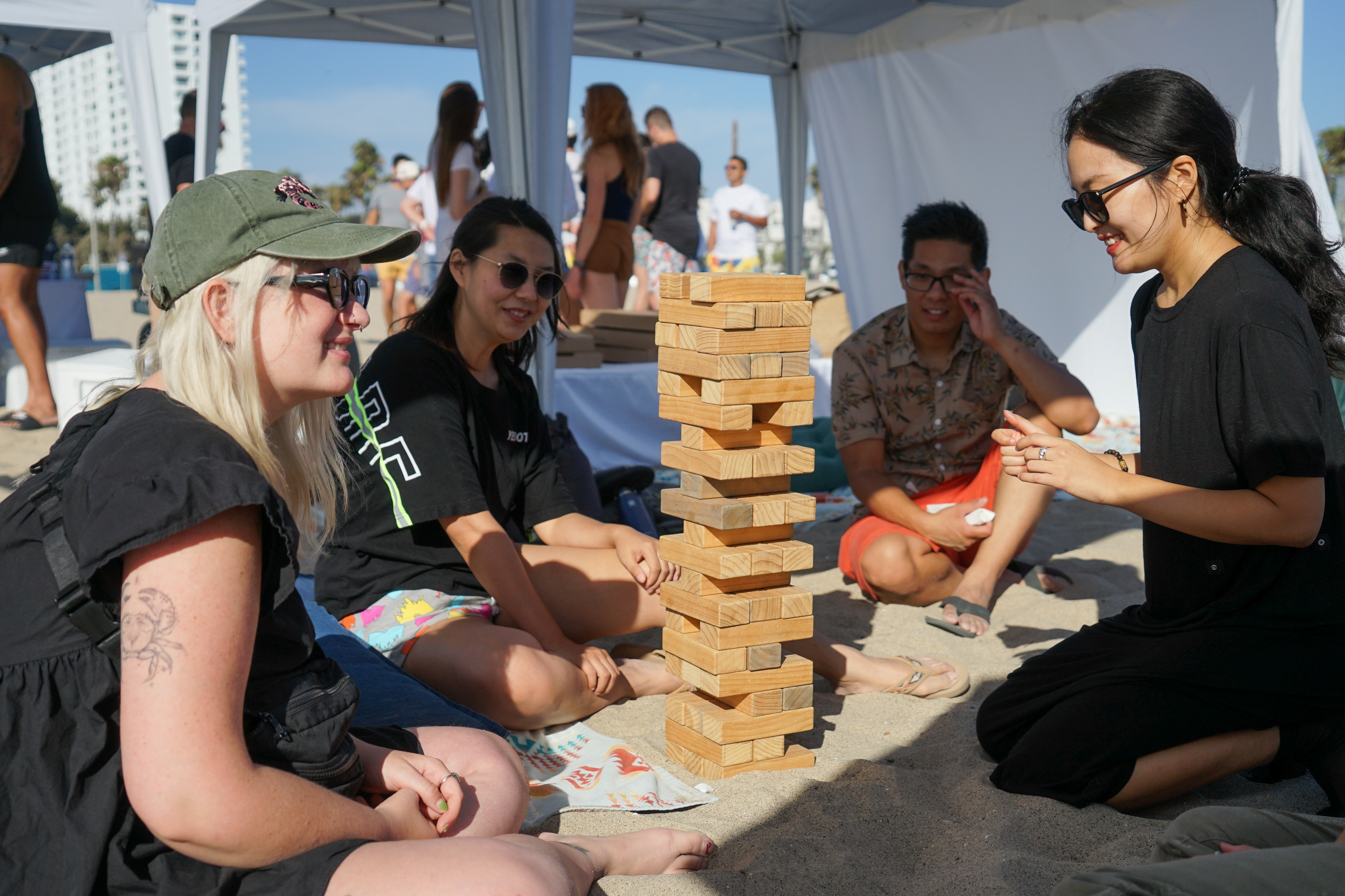 Tapcart team members play giant Jenga at an off-site event