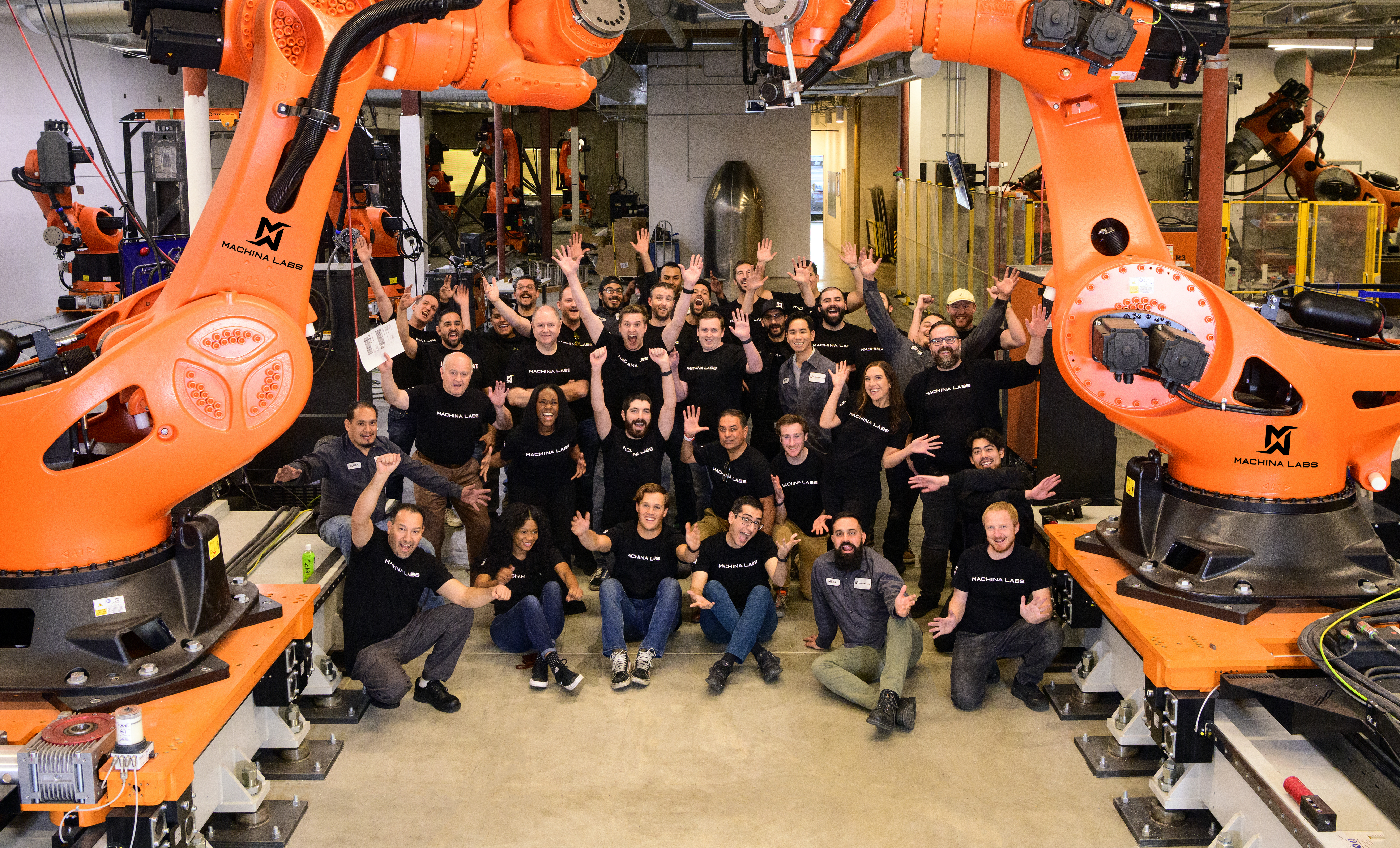 A group of Machina Labs employees pose together.