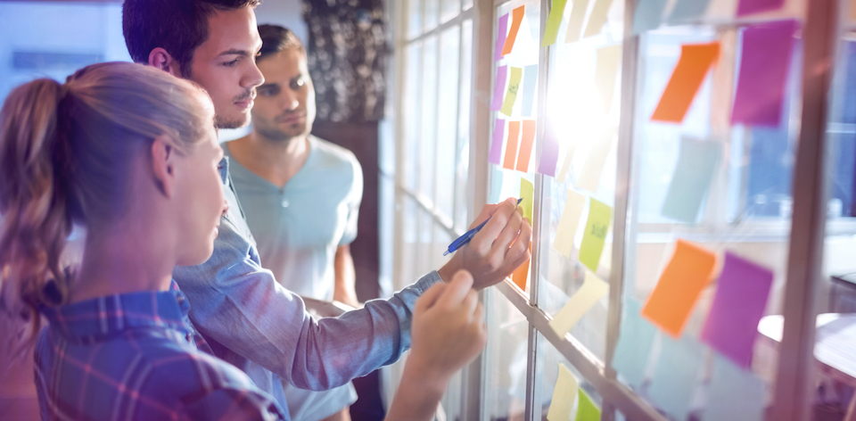 Team of workers together at whiteboard