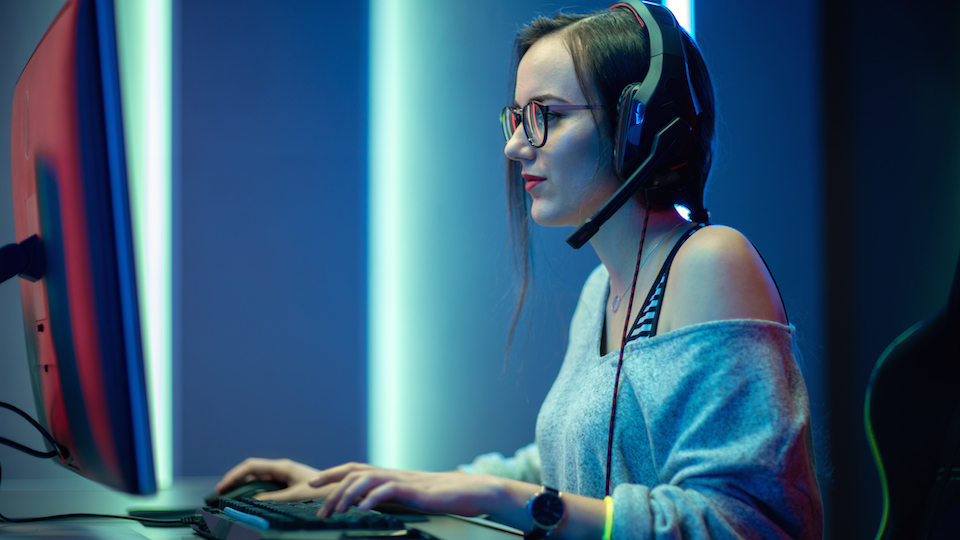 Female playing e-sports game with headset