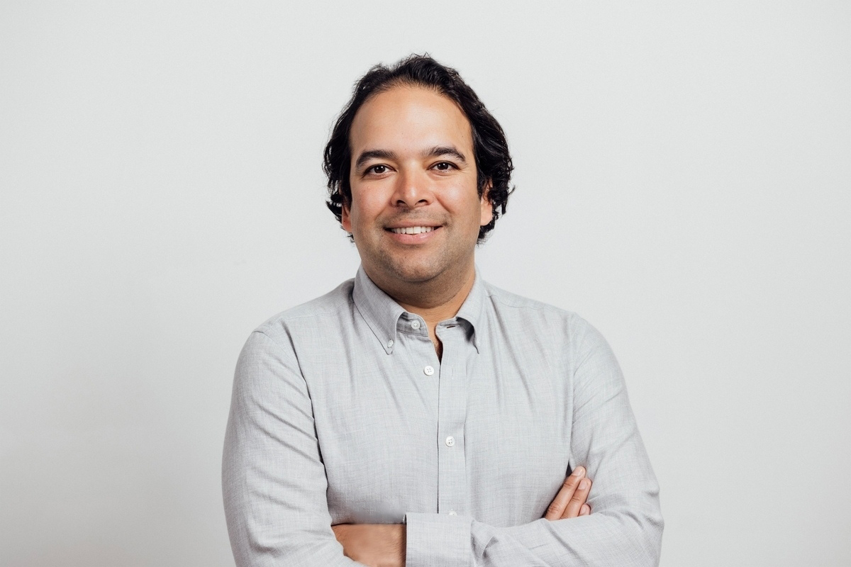 Sudhin Shahani, co-founder of Surf Air Mobility stands in front of a white background