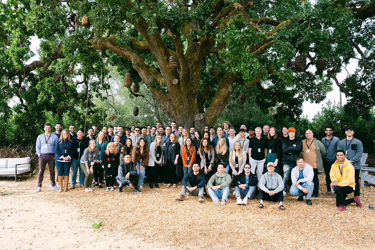 Sure team photo outside under a large tree