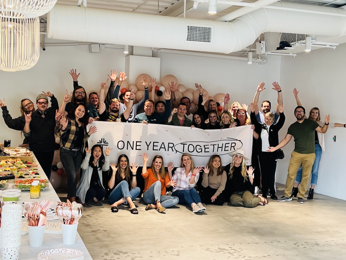 The Tebra team holds a banner that reads "One Year Together"