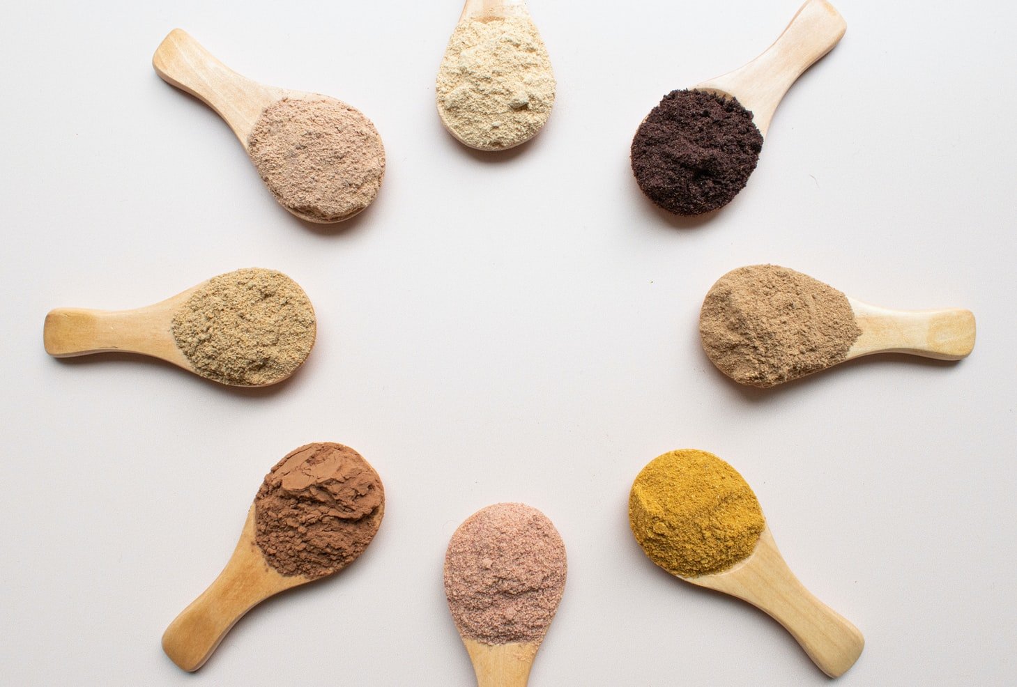 Powdered superfoods arranged on individual spoons.