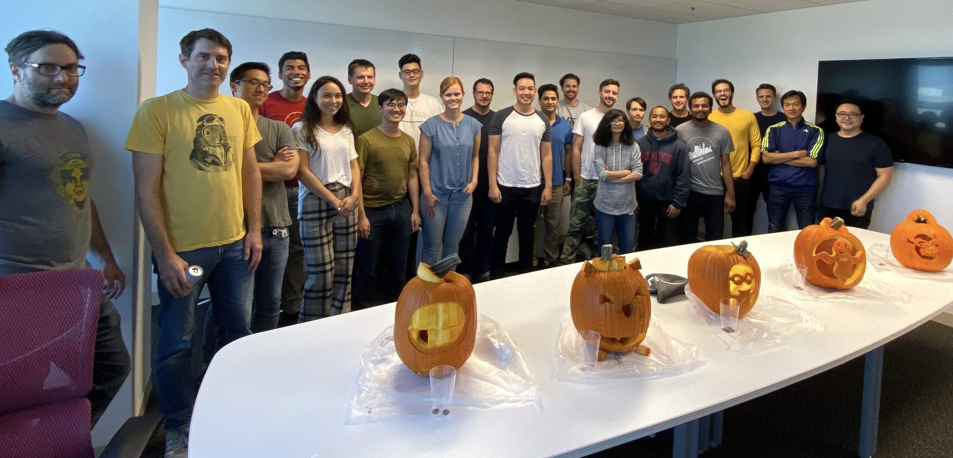 Ace Metrix team members gathered together at company pumpkin carving contest
