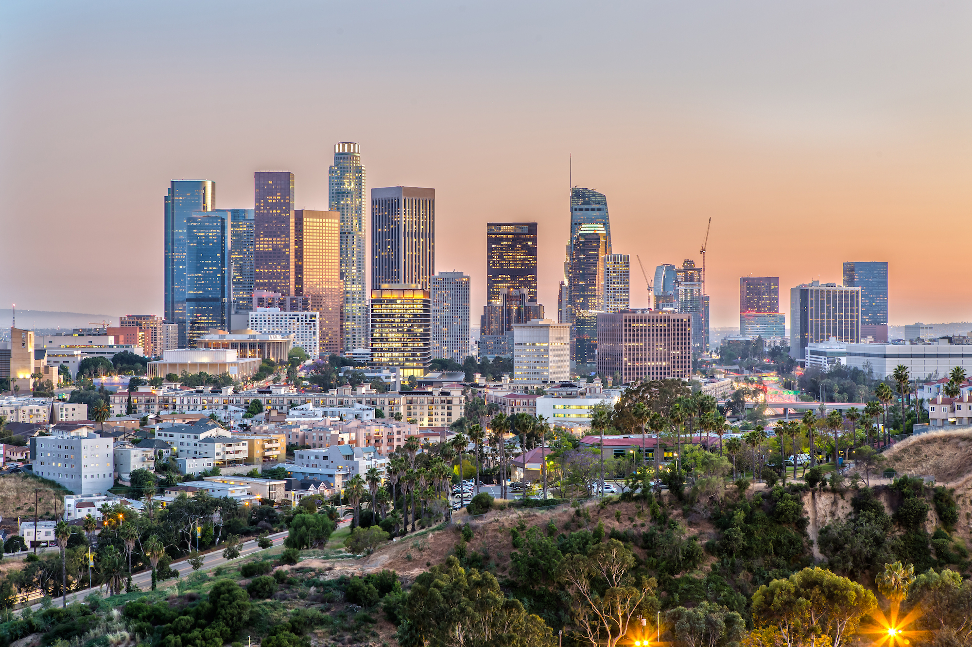 The downtown Los Angeles skyline during sunset.