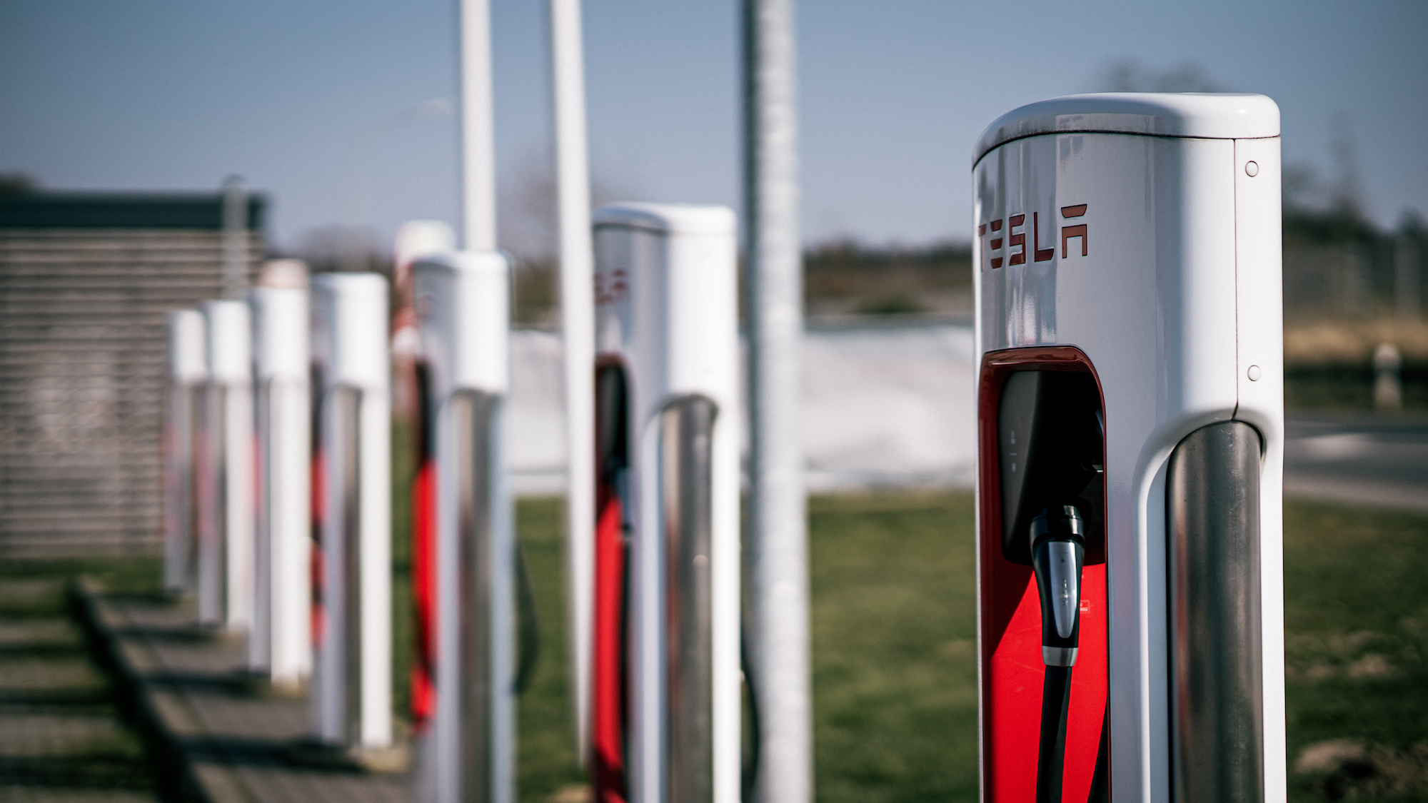 A row of Tesla charging stations is pictured.