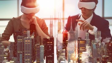 Two people look through virtual reality glasses at a holographic city.