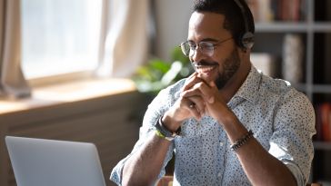 A customer success manager chats with a customer over the phone.