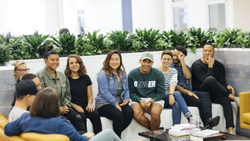 Photo of Foursquare employees gathered on a couch.