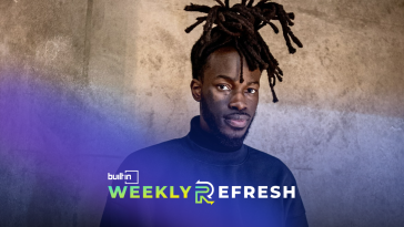 Spatial Labs founder and CEO Iddris Sandu poses for a photo against a concrete wall.