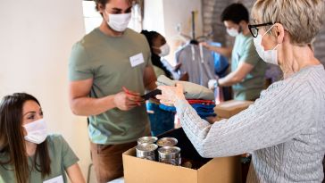 Group of people handing doing volunteer work.