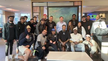 The Ballislife team gathers around a table.