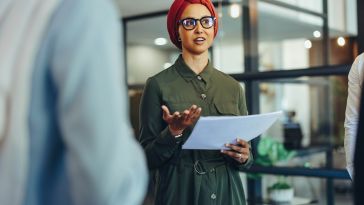 Photo of a business woman with a head wrap. 