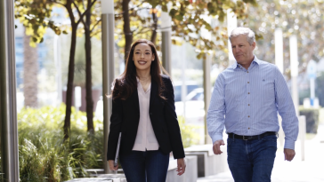 DIRECTV's Kamilah Jackson walking outside of the company's offices with a colleague