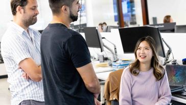 coworkers chatting in an office setting