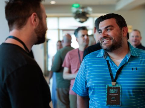 Huntress Co-Founder Chris Bisnett greets employees at the company’s annual in-person Summer Summit event. 